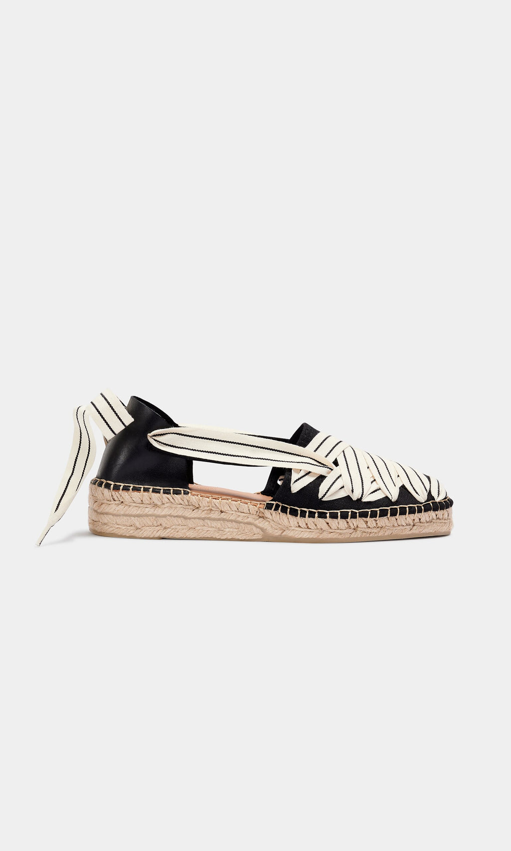 Plümo- The Ribbon Espadrilles feature black and white stripes, cut-out sides, and a jute wedge sole in a woven flat design.