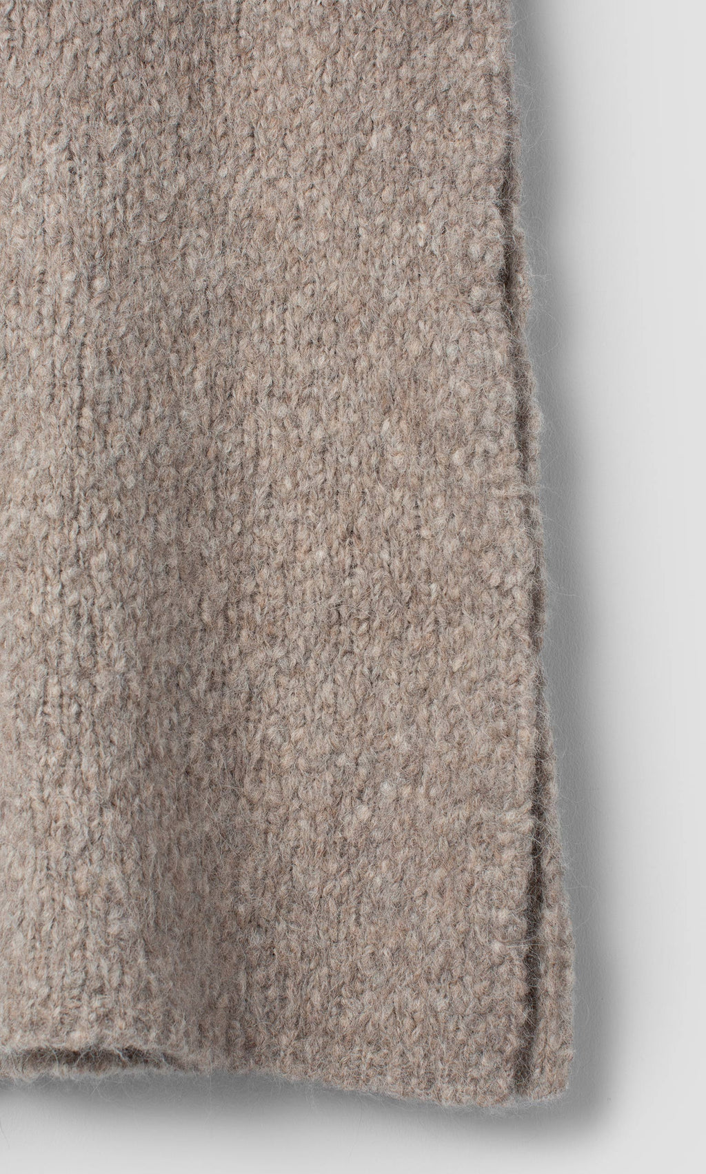 Plümo  Close-up of a taupe Borwick Tunic featuring a vertical side seam.