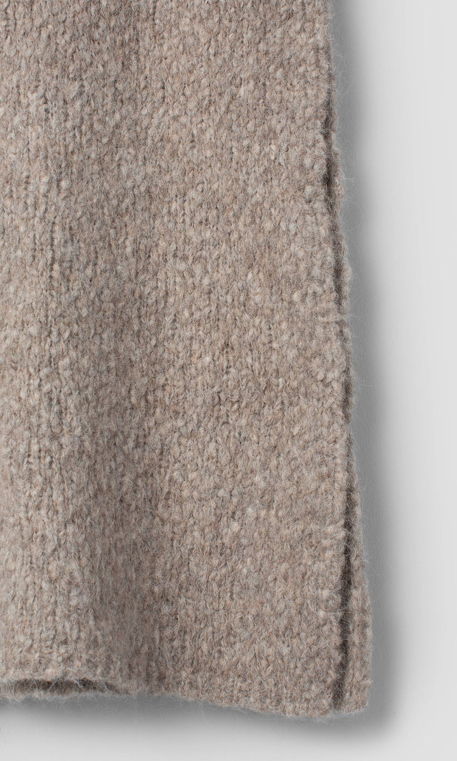 Plümo  Close-up of a taupe Borwick Tunic featuring a vertical side seam.