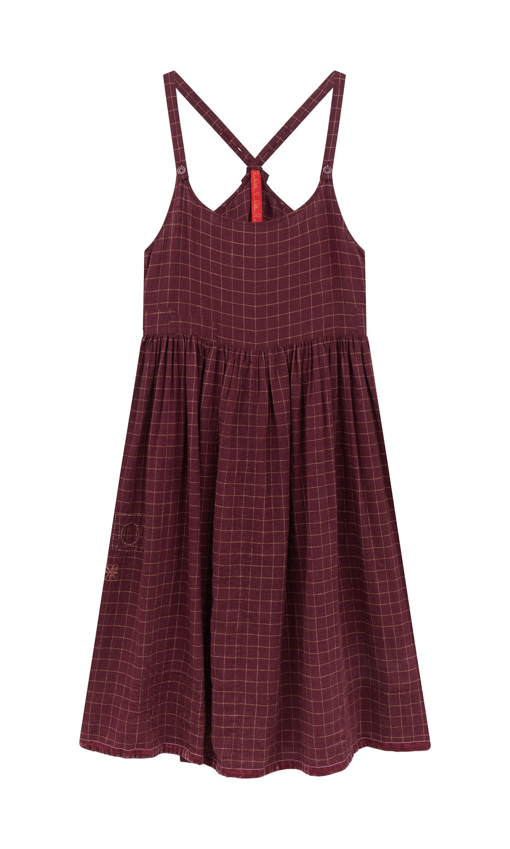 Plümo- The Anja Dress is a sleeveless burgundy linen apron dress with a chequered pattern and crisscross back straps.