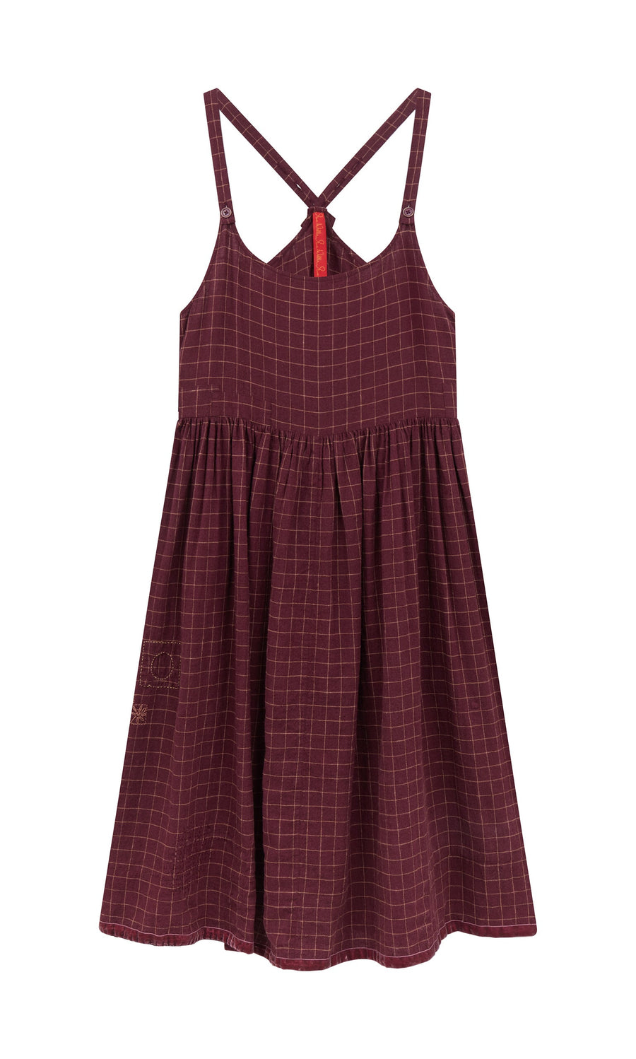 Plümo- The Anja Dress is a sleeveless burgundy linen apron dress with a chequered pattern and crisscross back straps.