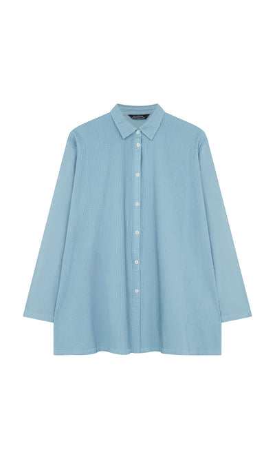 Plümo- Light blue Leung Shirt by Yacco Maricard—pintucked cotton, long-sleeve, collared button-up on white background.