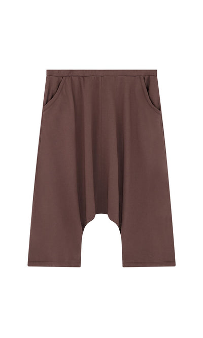 Plümo- Sybel Pants: brown knee-length jersey with wide legs, side pockets, and dropped-crotch on a white background.