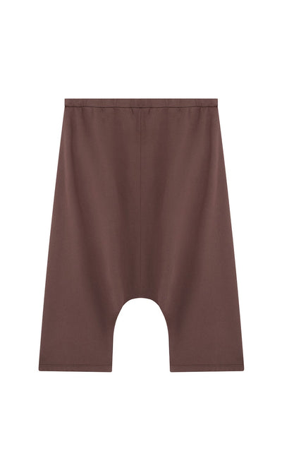 Plümo- Sybel Pants: Brown wide-leg, knee-length shorts with dropped-crotch and elastic waistband on white background.
