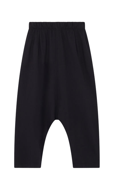 Plümo- Nerula Pants: black jersey with elastic waistband, cropped leg, and dropped-crotch, laid flat on a white background.
