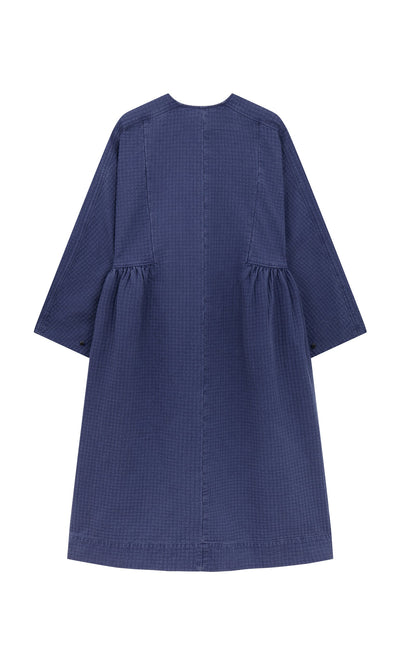 Plümo- Back view of the Matilda Dress featuring a full skirt, long sleeves, and gathered sides, made in London.