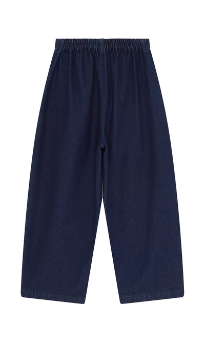Plümo- Barrel Pants Indigo: dark denim wide-leg jeans with elastic waistband, made in England, shown flat on white.