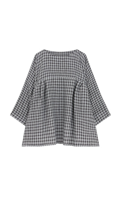 Plümo- The Kelli Blouse - Plaid features a loose fit, long sleeves, wide neckline, and ruffled hem in black and white plaid.
