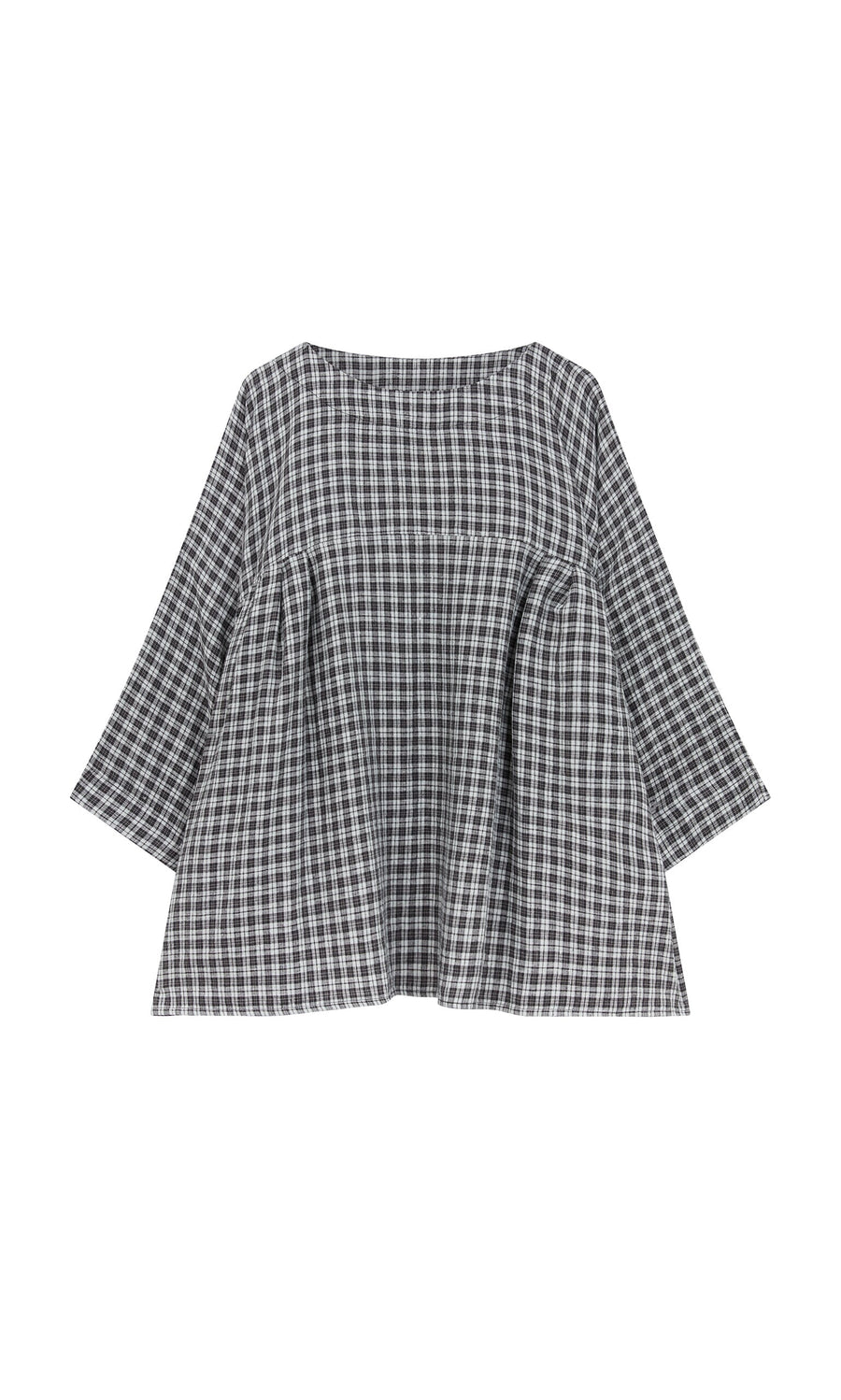 Plümo- The Kelli Blouse - Plaid features a loose fit, long sleeves, wide neckline, and ruffled hem in black and white plaid.