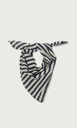 Plümo  Striped black, white, and beige bandana scarf tied in a knot, displayed on a plain light background.