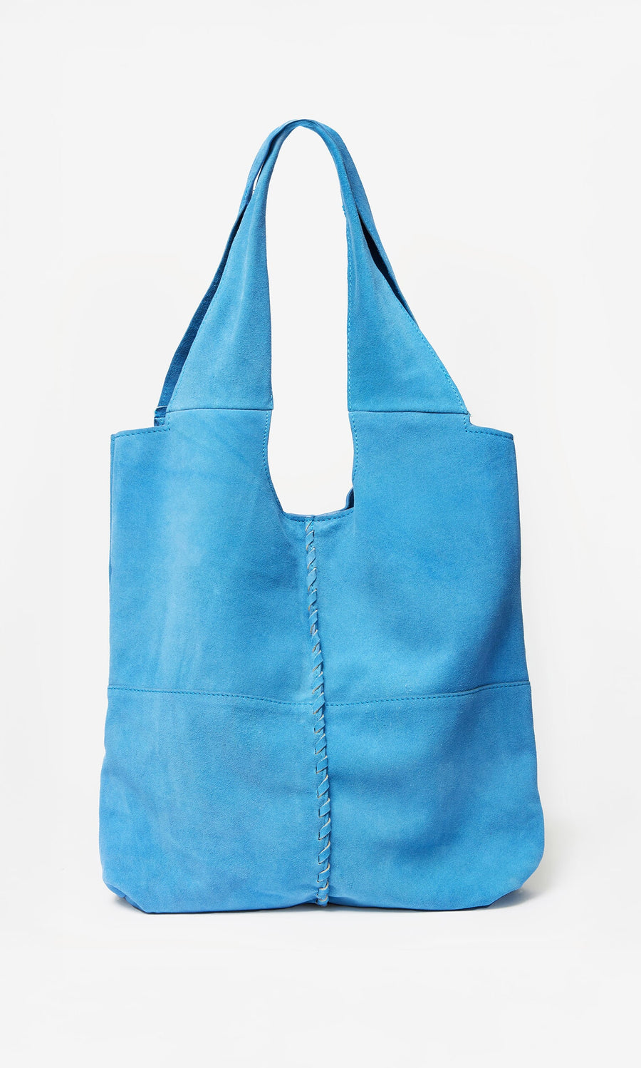 Plümo- The Alves Bag is bright blue suede with whip stitch seams and wide handles, shown against a white background.