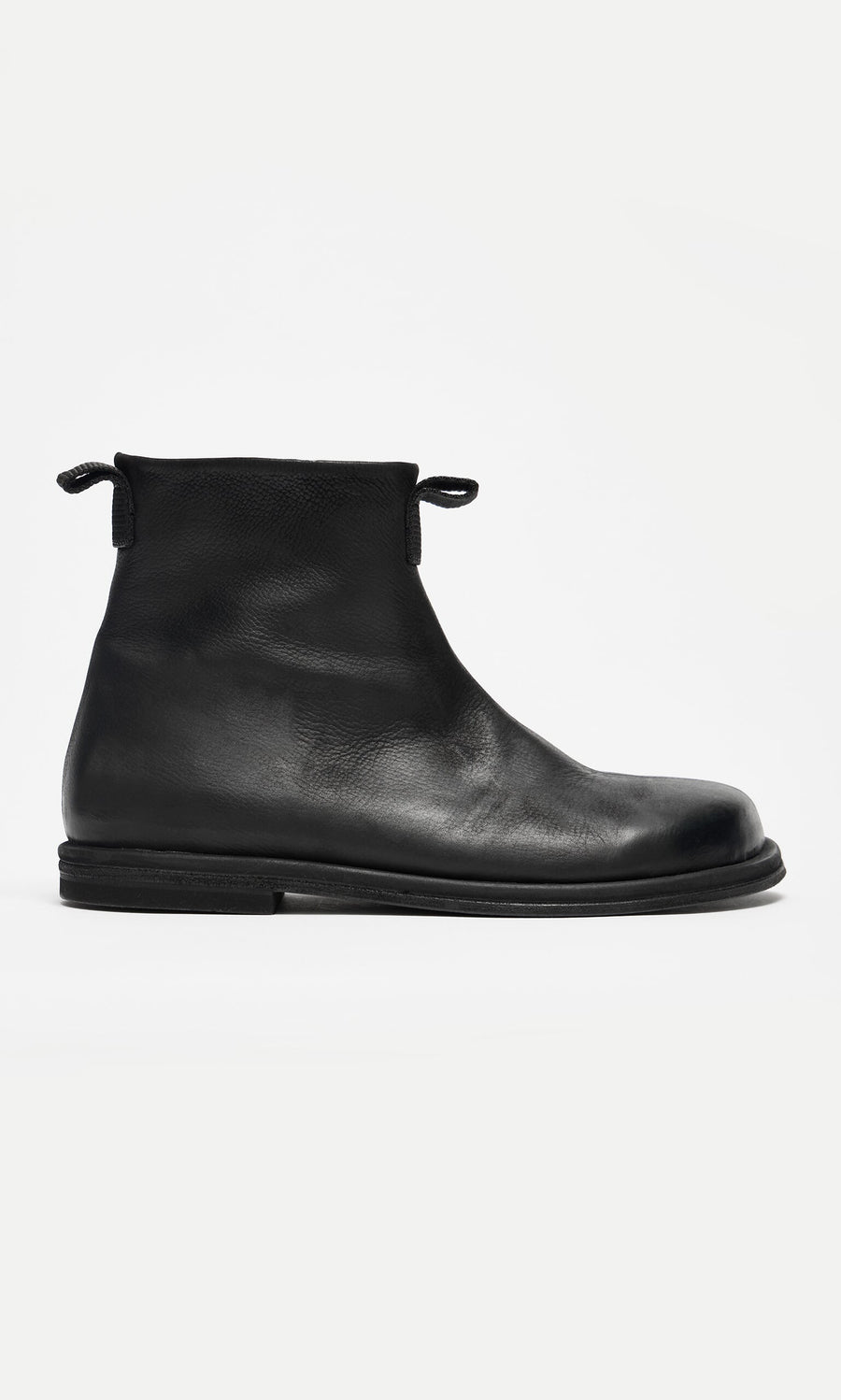Plümo- Ancona Boots: Black waxy leather ankle boots with round toe, flat sole, and pull tabs, Danish-inspired design.