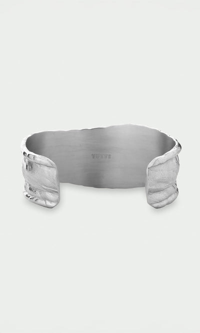 Plümo- The Bastion Bangle features an organic, textured edge and smooth interior, crafted from recycled silver jewelry.