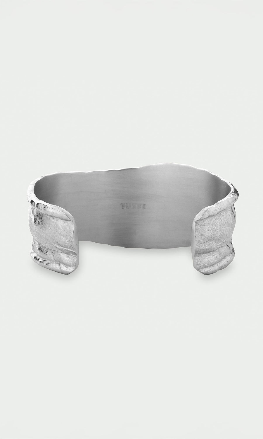 Plümo- The Bastion Bangle features an organic, textured edge and smooth interior, crafted from recycled silver jewelry.
