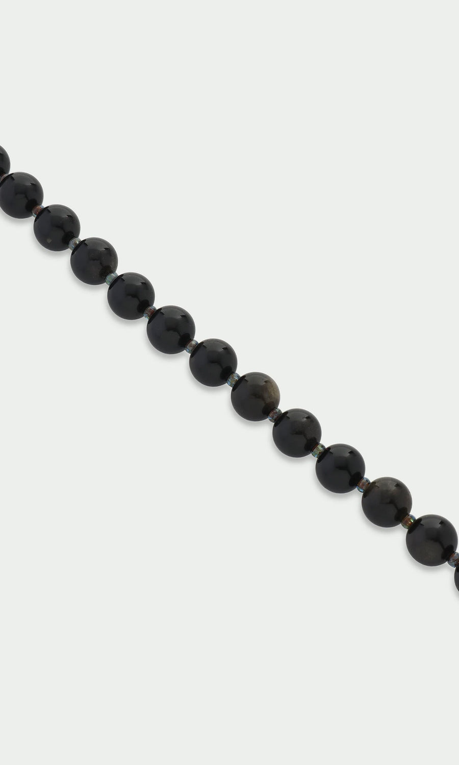 Plümo- A strand of glossy black beads—Obsidian Bracelet—set against a plain white background.