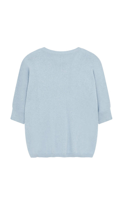 Plümo- Light blue Batwing Jumper with short sleeves and relaxed fit, back view on white background.