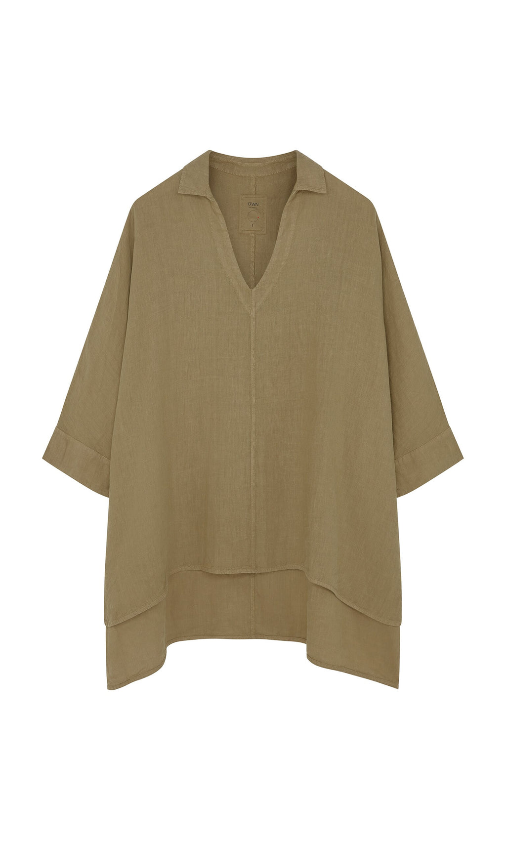 Plümo- The Bergman Blouse is a loose linen top with a V-neck, drop shoulders, short sleeves, and an asymmetrical hem.