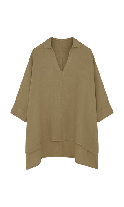Plümo- The Bergman Blouse is a loose linen top with a V-neck, drop shoulders, short sleeves, and an asymmetrical hem.