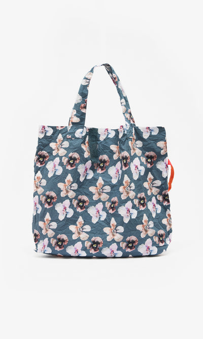Plümo  Dahlia Tote: Lightweight cotton bag with blue floral print, two handles, and a right-side orange accent.
