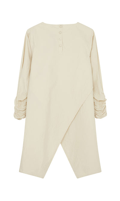 Plümo  Clementine Blouse: Beige long-sleeve with ruched sleeves, buttoned back, and asymmetrical overlapping hem.