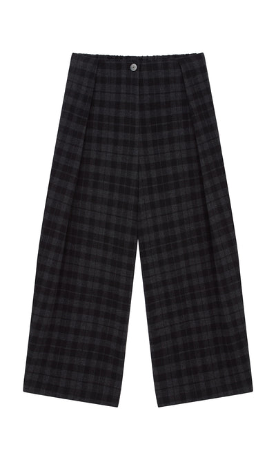 Plümo  Tartan Flannel Pants in black and dark gray plaid with button closure, wide-leg style, shown flat on a white background.