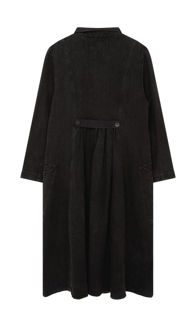 Plümo  The Fowey Coat: a long black corduroy vintage-style coat with front pockets and buttoned waist, shown from the back.