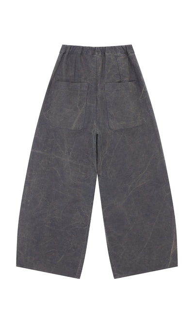Plümo  Corfe Barrel Pants: wide-leg, dark gray cotton canvas with two large back pockets, shown flat on white.