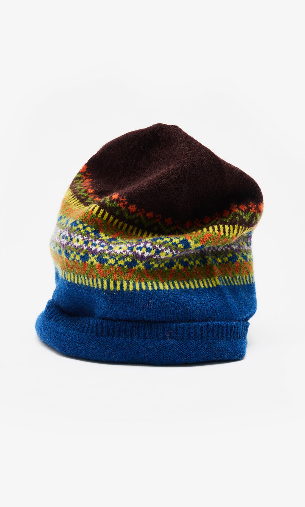 Plümo  Colorful wool beanie with blue base, fairisle patterns in yellow and red, and a dark brown top on a white background.
