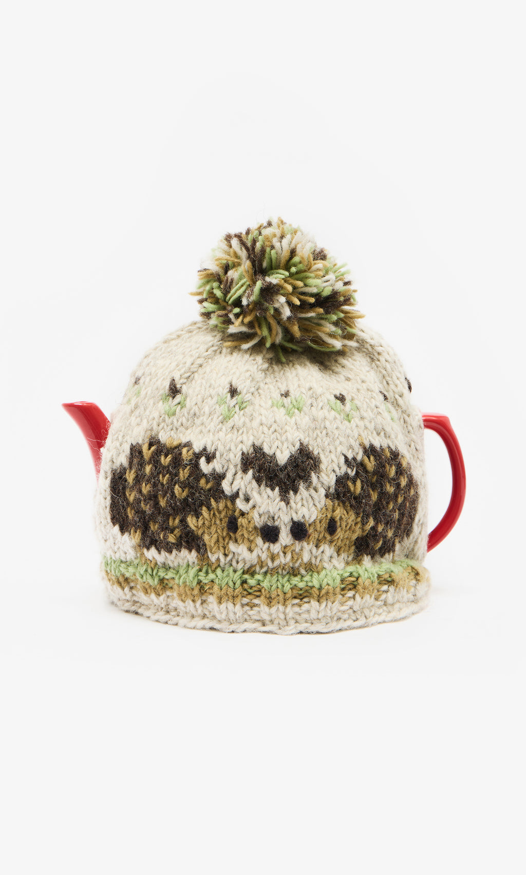 Plümo  Red teapot with Hedgehog Tea Cosy, fairtrade, hand-knitted, large pom-pom, on a white background.