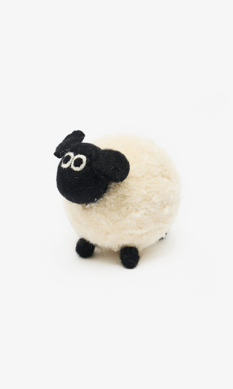 Plümo  The Diana White Sheep is a small, round plush toy with a black face and legs, handcrafted from fairtrade felt in Nepal.