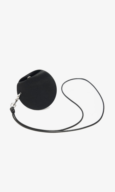 Plümo  Coin Purse on String—black leather, circular design with snap closure and neck strap, made in Italy, shown on white.