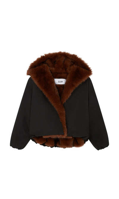 Plümo  Lenz Parka: Black faux fur jacket with oversized hood, acorn brown lining, shown on a white background.