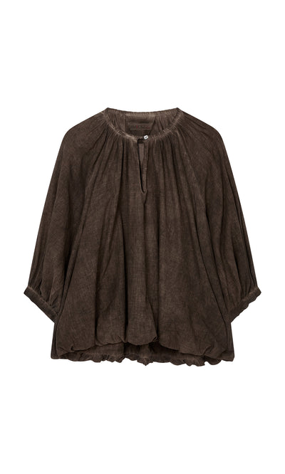 Plümo  Loose, dark brown, long-sleeve cotton blouse with gathered neckline, bubble hem, and a single button at the collar.