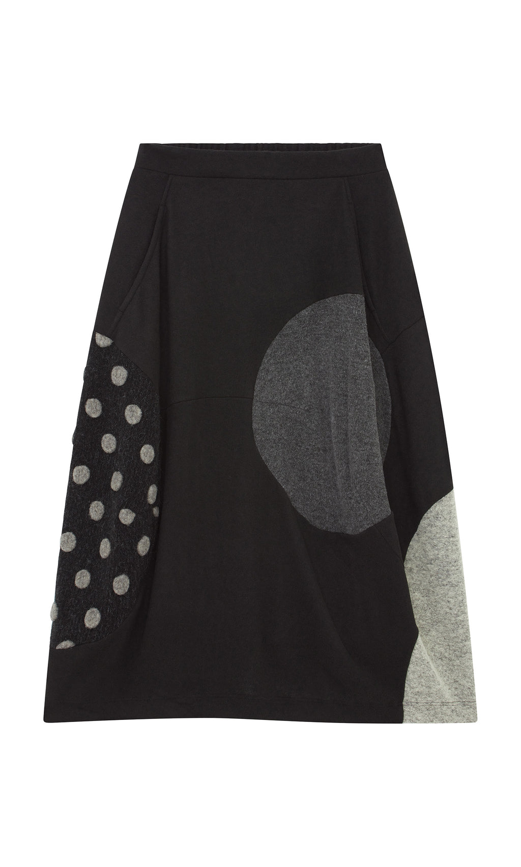 Plümo  The Felted Bubble Skirt is black, knit, midi-length with gray and polka dot patchwork near the hem.