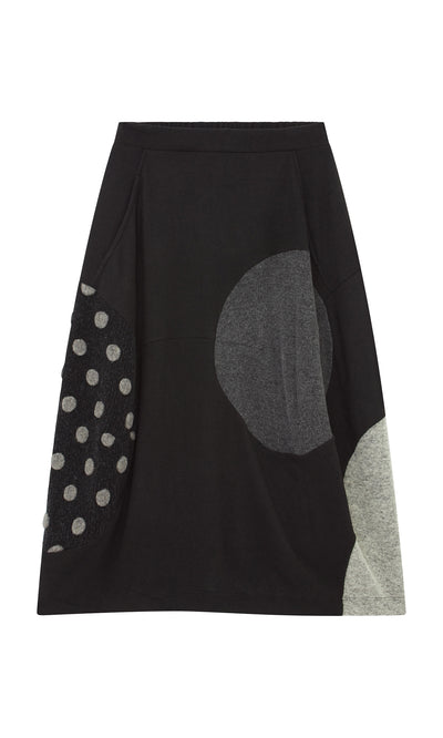 Plümo  The Felted Bubble Skirt is black, knit, midi-length with gray and polka dot patchwork near the hem.