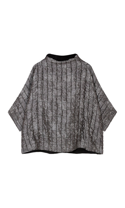 Plümo  Jorn Top: Gray, oversized boxy top with crinkled texture and vertical black stripes on a plain background.