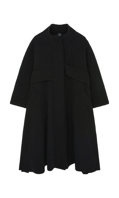Plümo  Brabant Coat: Black bouclé wool, flared peplum waist, round pockets, high collar—crafted in Italy.