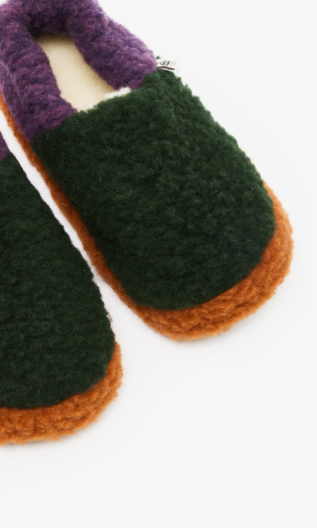 Plümo  Pair of Wool Slippers - Violet with green tops, orange non-slip soles, and purple cuffs on a white background.