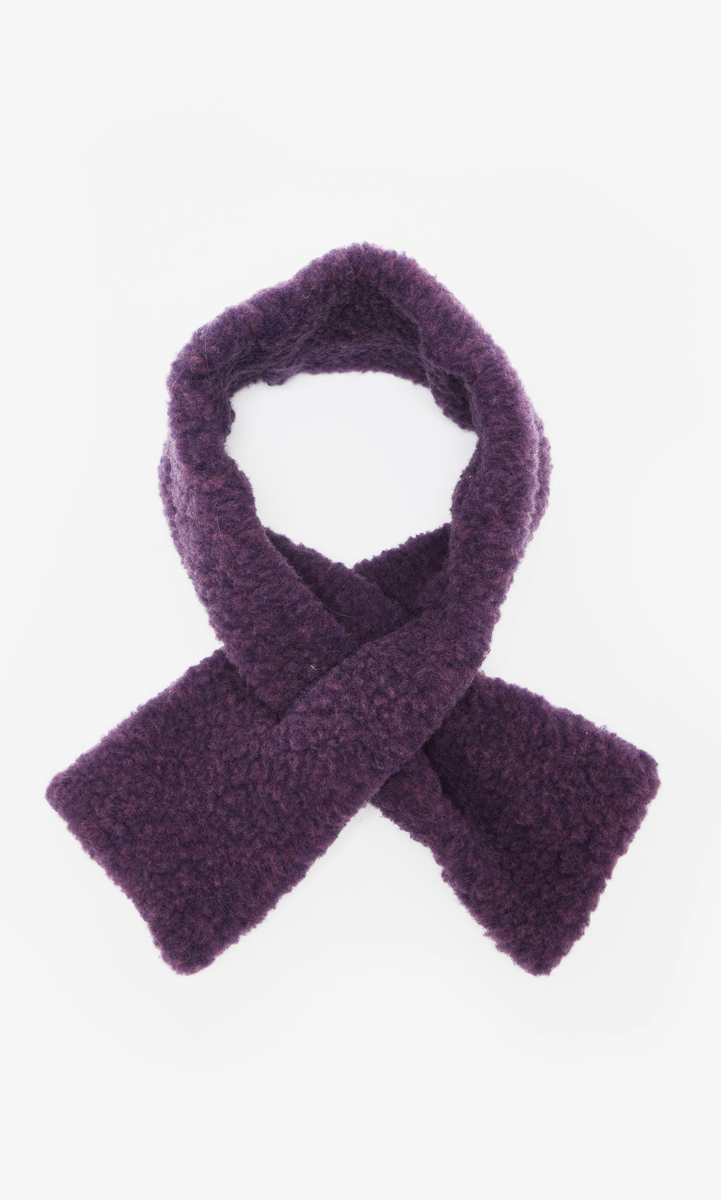 Plümo  The Betty Scarf, a textured dark purple pull-through style, is crossed and laid flat on a white background.