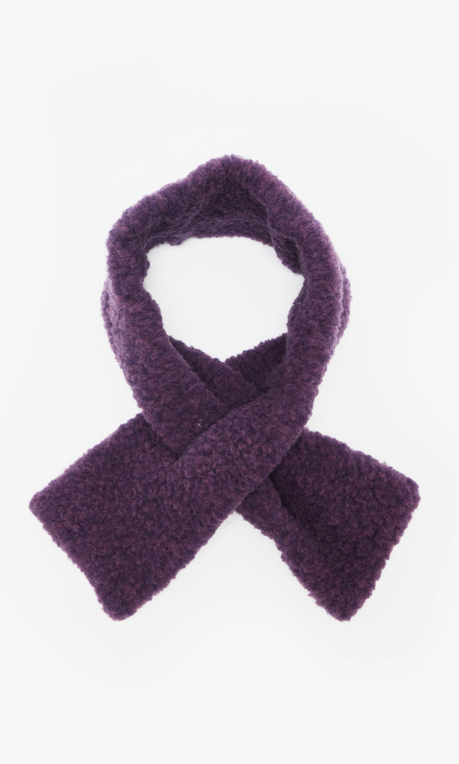 Plümo  The Betty Scarf, a textured dark purple pull-through style, is crossed and laid flat on a white background.