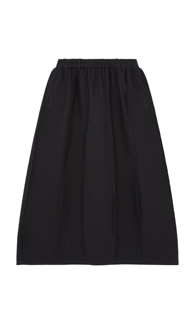 Plümo  Yoshiko Bubble Skirt in black, midi-length with elastic waist and pleats, shown on a white background.