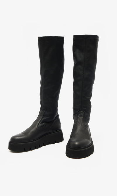Plümo  Long Prato Boots: sustainably produced black knee-high boots with chunky ridged soles on a white background.