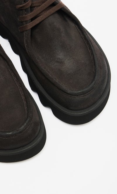 Plümo  Close-up of Rolla Boots in mocha suede with thick black platform soles on a white background.
