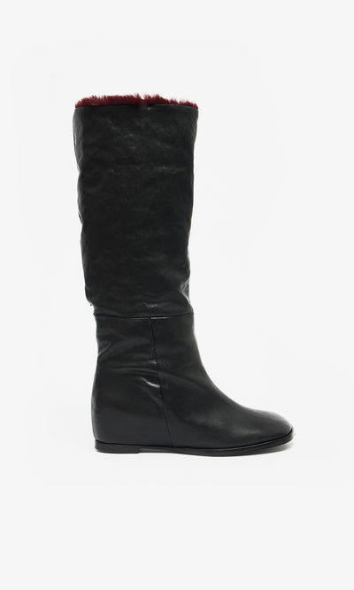 Plümo  Briony Boots: knee-high black leather with hidden wedge and dark red faux fur trim, on white background.