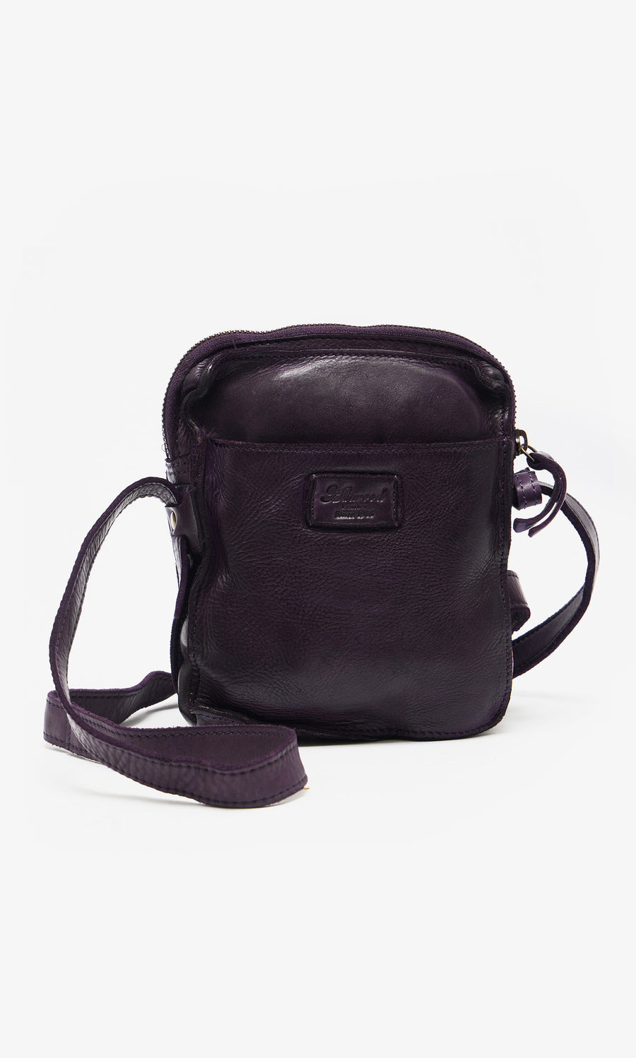 Plümo  Loyd Bag: Small dark purple leather pouch with zipper, long strap, and front logo patch on white background.