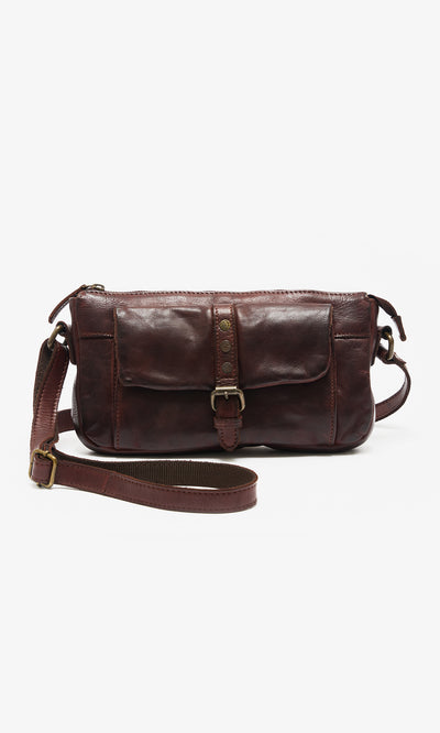 Plümo  Luxton Bag: dark brown chestnut satchel with front buckle, studs, and adjustable strap on white background.