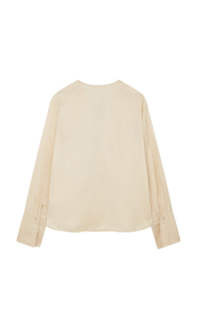 Plümo  Silk Shirt in cream, back view; British-inspired with buttoned cuffs and soft, lightweight fabric.