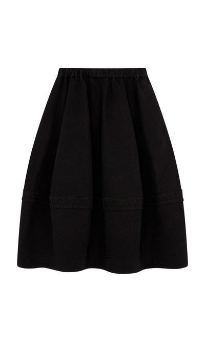 Plümo  Rho Skirt - Coal: Black quilted skirt with flared silhouette and elastic waistband for effortless, stylish comfort.