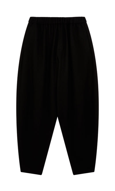 Plümo  Circle Pants - Boiled Black: wool, elastic waist, made in London. Effortlessly stylish, shown flat on white.
