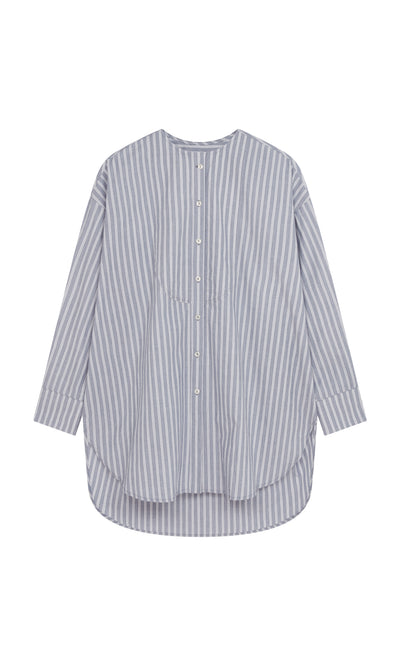 Plümo  Tuxedo Shirt: collarless, chambray blue stripes, buttons, curved hem—modern style for a classic men’s look.